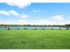 Scenic golf driving range overlooking a lake with golfers practicing on a sunny day at 12672 Fontana Loop, Bradenton, FL 34211