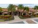 Striking building showcasing tile roofing, lush landscaping, and elegant entryway with festive wreaths at 12672 Fontana Loop, Bradenton, FL 34211
