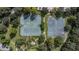 Aerial view of tennis and basketball courts surrounded by lush greenery in a community park at 12746 Standbridge Dr, Riverview, FL 33579