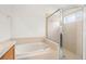 Bright bathroom featuring a soaking tub and glass door shower at 12746 Standbridge Dr, Riverview, FL 33579