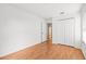 Bedroom with wood floors, closet, and entry to hallway at 12746 Standbridge Dr, Riverview, FL 33579