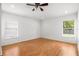 Large, empty bedroom with hardwood floors, large window, and ceiling fan at 12746 Standbridge Dr, Riverview, FL 33579