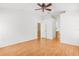 Empty bedroom featuring hardwood floors, two windows, and ceiling fan at 12746 Standbridge Dr, Riverview, FL 33579