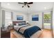 Relaxing primary bedroom with hardwood floors, ceiling fan, and ample windows at 12746 Standbridge Dr, Riverview, FL 33579