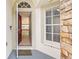 An open front door reveals a tiled foyer and a glimpse into the spacious living areas of the home at 12746 Standbridge Dr, Riverview, FL 33579