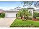 Charming single-story home featuring a two-car garage, mature landscaping, and a well-manicured lawn at 12746 Standbridge Dr, Riverview, FL 33579