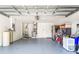 Spacious two car garage with utility sink, storage, and epoxy floor at 12746 Standbridge Dr, Riverview, FL 33579