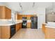 Spacious kitchen with wood cabinets, modern black appliances, and tile floors at 12746 Standbridge Dr, Riverview, FL 33579
