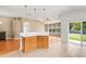 Kitchen with wood cabinets open to the living area and outdoor patio at 12746 Standbridge Dr, Riverview, FL 33579