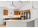 Bright kitchen features wood cabinets, modern black appliances, and white countertops at 12746 Standbridge Dr, Riverview, FL 33579