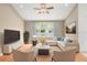 Bright living room with hardwood floors, large window, and comfortable seating at 12746 Standbridge Dr, Riverview, FL 33579