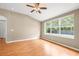 Comfortable living room featuring hardwood floors, a ceiling fan, and a large window with backyard views at 12746 Standbridge Dr, Riverview, FL 33579