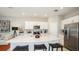 Spacious kitchen with white cabinets, stainless steel appliances, and an island with seating at 13248 Stable Pl, Parrish, FL 34219