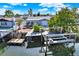 Aerial view of home with wooden dock, boat lift and waterway access at 13926 Darlene Ave, Hudson, FL 34667