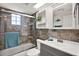 Bathroom featuring a glass shower door, tile walls, and modern vanity at 13926 Darlene Ave, Hudson, FL 34667
