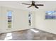 Bedroom with a ceiling fan, three windows, and neutral paint at 13926 Darlene Ave, Hudson, FL 34667