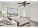 Comfortable bedroom featuring a ceiling fan, large picture frame and ample closet space at 13926 Darlene Ave, Hudson, FL 34667