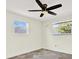 Cozy bedroom with natural light, ceiling fan, and neutral paint at 13926 Darlene Ave, Hudson, FL 34667