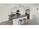 Well-lit kitchen featuring stainless steel appliances, white cabinetry, tile backsplash, and a breakfast bar with seating at 13926 Darlene Ave, Hudson, FL 34667