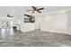 Spacious living room featuring a kitchen bar, decorative art, and tile flooring at 13926 Darlene Ave, Hudson, FL 34667