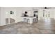 Open living area with tile flooring, kitchen bar, and natural light at 13926 Darlene Ave, Hudson, FL 34667