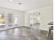 Bright living area with sliding glass doors, tile flooring, a gray bar stool, and access to the kitchen at 13926 Darlene Ave, Hudson, FL 34667