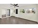 Bright sun room features three large windows, tile flooring, and a ceiling fan at 13926 Darlene Ave, Hudson, FL 34667