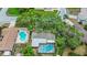 Aerial view of house with mature tree coverage, in-ground pool and fenced in lanai at 14321 113Th Ave, Largo, FL 33774