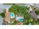 Aerial view of homes, pools and street in residential neighborhood with mature trees at 14321 113Th Ave, Largo, FL 33774