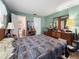 Bedroom with green walls, coordinated furniture, and a connecting en-suite bathroom at 14321 113Th Ave, Largo, FL 33774