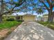 Charming home featuring a well-kept lawn, mature trees, and a welcoming two-car garage at 14321 113Th Ave, Largo, FL 33774