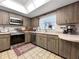 Traditional kitchen featuring wood cabinets, neutral countertops, tile floors, and stainless steel appliances at 14321 113Th Ave, Largo, FL 33774