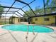 Backyard view of enclosed swimming pool with patio and attached to the home at 14321 113Th Ave, Largo, FL 33774