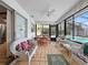 Bright sunroom with tile floor, ceiling fan, and sliding doors to pool area at 14321 113Th Ave, Largo, FL 33774
