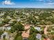 Panoramic aerial view of a luxury home nestled among lush greenery in a vibrant suburban community at 1470 Serpentine S Dr, St Petersburg, FL 33705