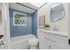 Stylist bathroom with blue tile and modern fixtures at 1470 Serpentine S Dr, St Petersburg, FL 33705