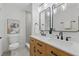 Bright bathroom with wood vanity, dual sinks, and modern fixtures at 1470 Serpentine S Dr, St Petersburg, FL 33705