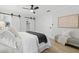 Well-lit bedroom with a ceiling fan, a comfortable bed, and light hardwood flooring at 1470 Serpentine S Dr, St Petersburg, FL 33705