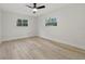 A simply designed bedroom with hardwood floors and a large window at 1470 Serpentine S Dr, St Petersburg, FL 33705