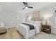 Well-lit bedroom with a ceiling fan, a comfortable bed, and light hardwood flooring at 1470 Serpentine S Dr, St Petersburg, FL 33705