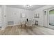 Bright dining area featuring a glass table, four chairs, and a large window at 1470 Serpentine S Dr, St Petersburg, FL 33705
