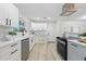 Modern kitchen featuring stainless steel appliances, quartz countertops, and white cabinets at 1470 Serpentine S Dr, St Petersburg, FL 33705
