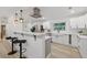Modern kitchen with stainless steel appliances, bright white cabinetry, and a stylish eat-in breakfast bar at 1470 Serpentine S Dr, St Petersburg, FL 33705