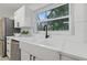 Modern kitchen featuring stainless steel appliances, quartz countertops, and white cabinets at 1470 Serpentine S Dr, St Petersburg, FL 33705