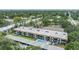 Aerial view of the multi-unit building, pool, trees, landscaping and city in the distance at 1485 Lakeview Rd # 19, Clearwater, FL 33756