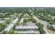A high aerial shot of the building, local neighborhood, trees and surrounding city at 1485 Lakeview Rd # 19, Clearwater, FL 33756
