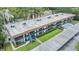 Wide aerial view of a multi-unit building with a pool, green space, and covered parking at 1485 Lakeview Rd # 19, Clearwater, FL 33756