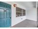 Inviting entryway featuring a teal door, ample lighting, and a secure lock system at 1485 Lakeview Rd # 19, Clearwater, FL 33756