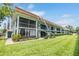 Two-story condo building featuring well-maintained landscaping, screened-in porch, and cozy exterior at 1485 Lakeview Rd # 19, Clearwater, FL 33756