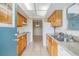 Well-lit kitchen featuring neutral countertops and wood cabinets, complete with essential appliances at 1485 Lakeview Rd # 19, Clearwater, FL 33756